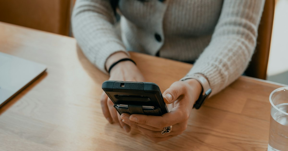 A person filling in a short form on a smartphone.